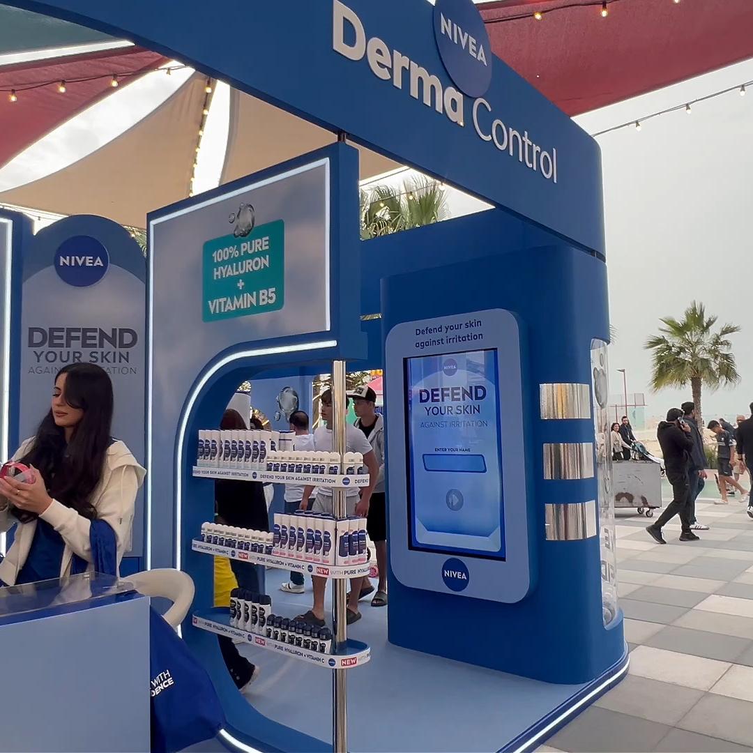 Guests playing the interactive Catch and Dodge game at a Niveae event in Dubai. Custom branded screen with data capture for exhibition marketing